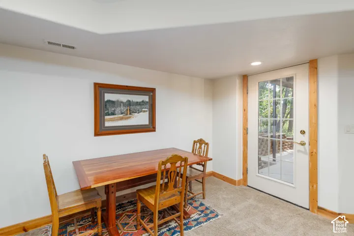 Glass-paned door with exterior access and an overhead recessed light