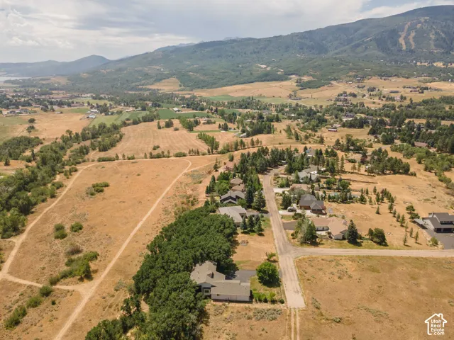 Expansive land parcel featuring natural terrain and distant mountain ranges
