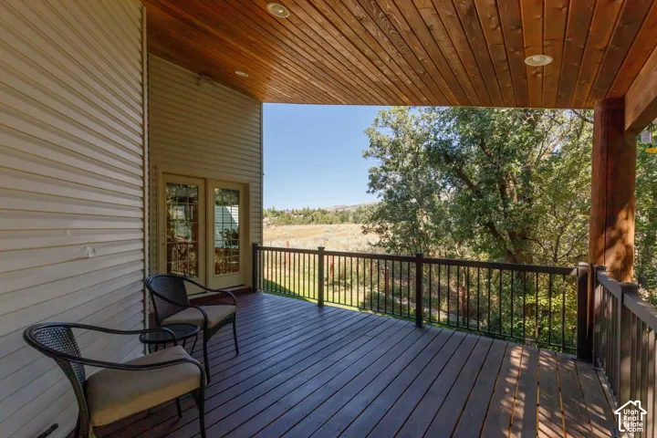 Covered deck featuring a wood plank ceiling and recessed lighting