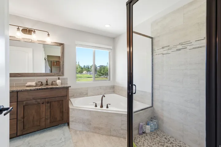 Walk-in shower with tile surround and glass enclosure