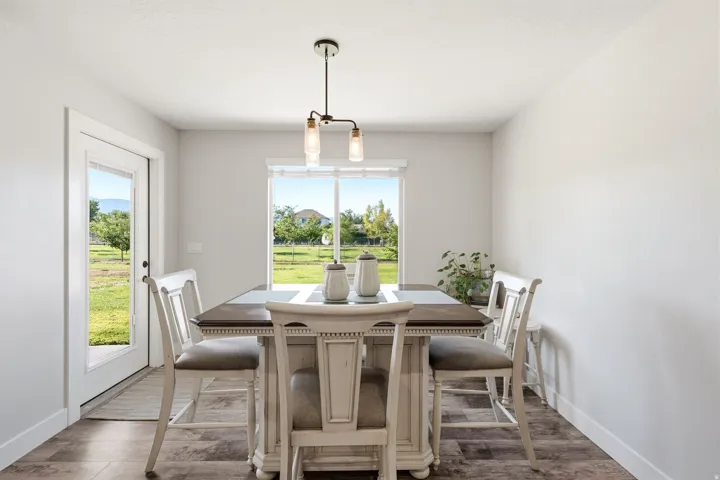 Wood-finish flooring, white walls, and a glass-paneled door