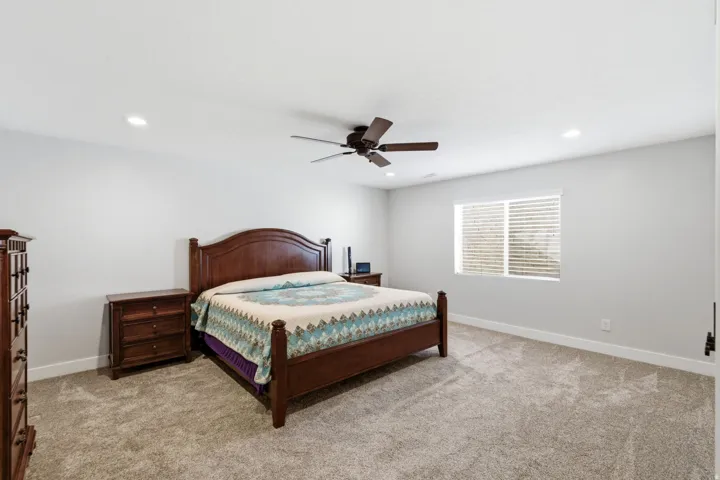 Wall-to-wall carpeting, recessed lighting, ceiling fan, window with blinds,