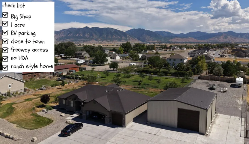 Ranch-style residence featuring a large detached workshop, extensive gravel parking, and a concrete driveway