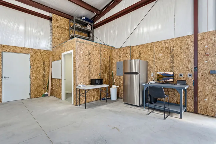 Concrete flooring with oriented strand board walls and a built-in elevated storage platform