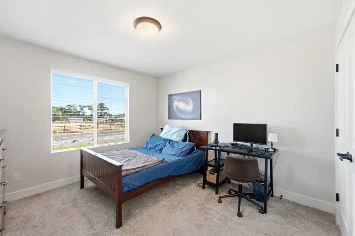 Neutral paint palette, carpeted flooring, white trim, recessed lighting, and a white paneled door with matte black hardware