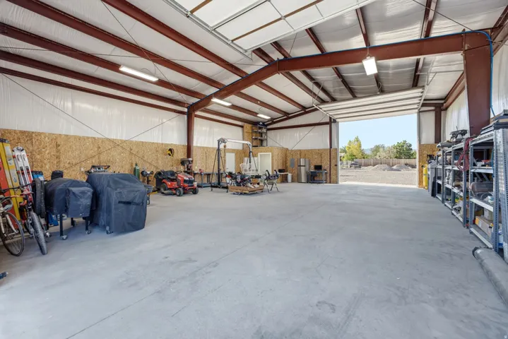 Expansive interior warehouse space with a concrete floor, exposed steel beam construction, and overhead lighting