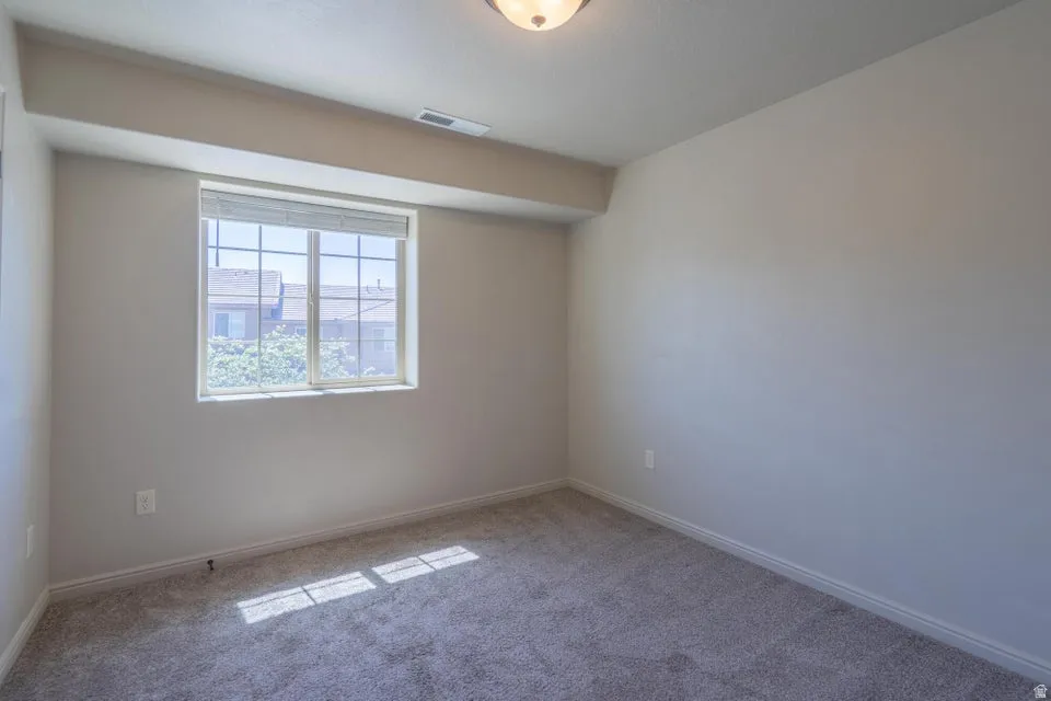 Neutral tone walls with gray carpeting