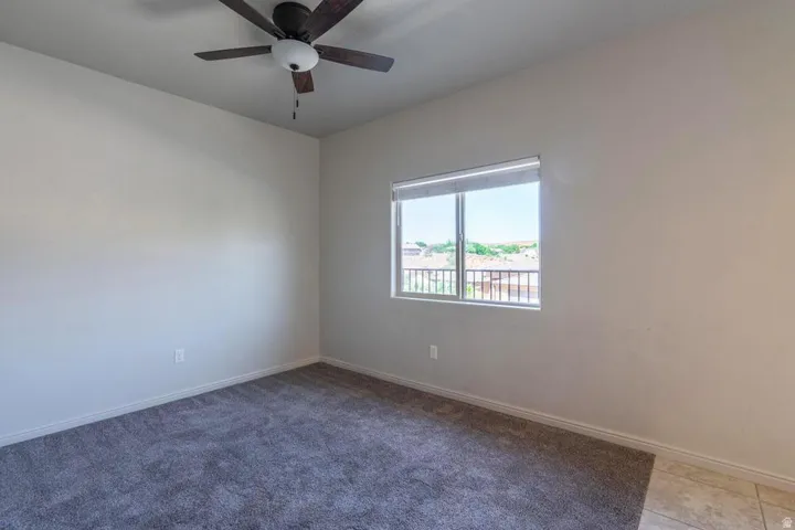 Room featuring light-colored walls and grey carpeting