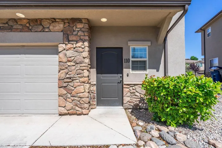 Exterior facade featuring stone veneer accents and a dark entry door
