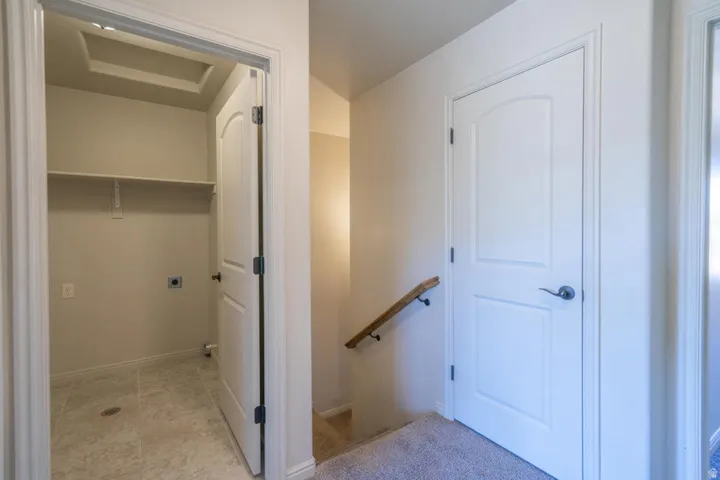 Dedicated utility space featuring tile flooring and built-in shelving
