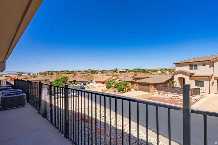 Outdoor balcony featuring a black metal railing and concrete flooring