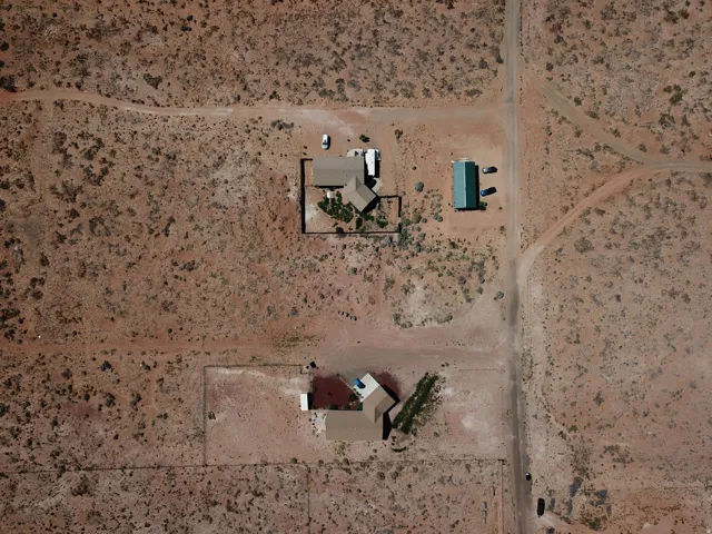 Expansive desert landscape with multiple structures and dirt roads