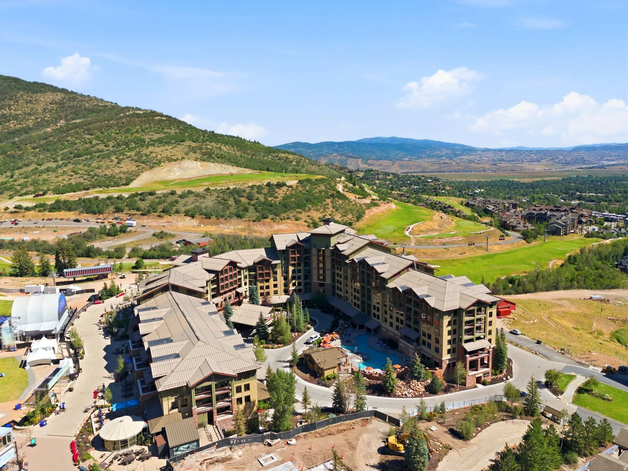 Mountain resort-style architecture featuring multiple balconies and a central outdoor pool area