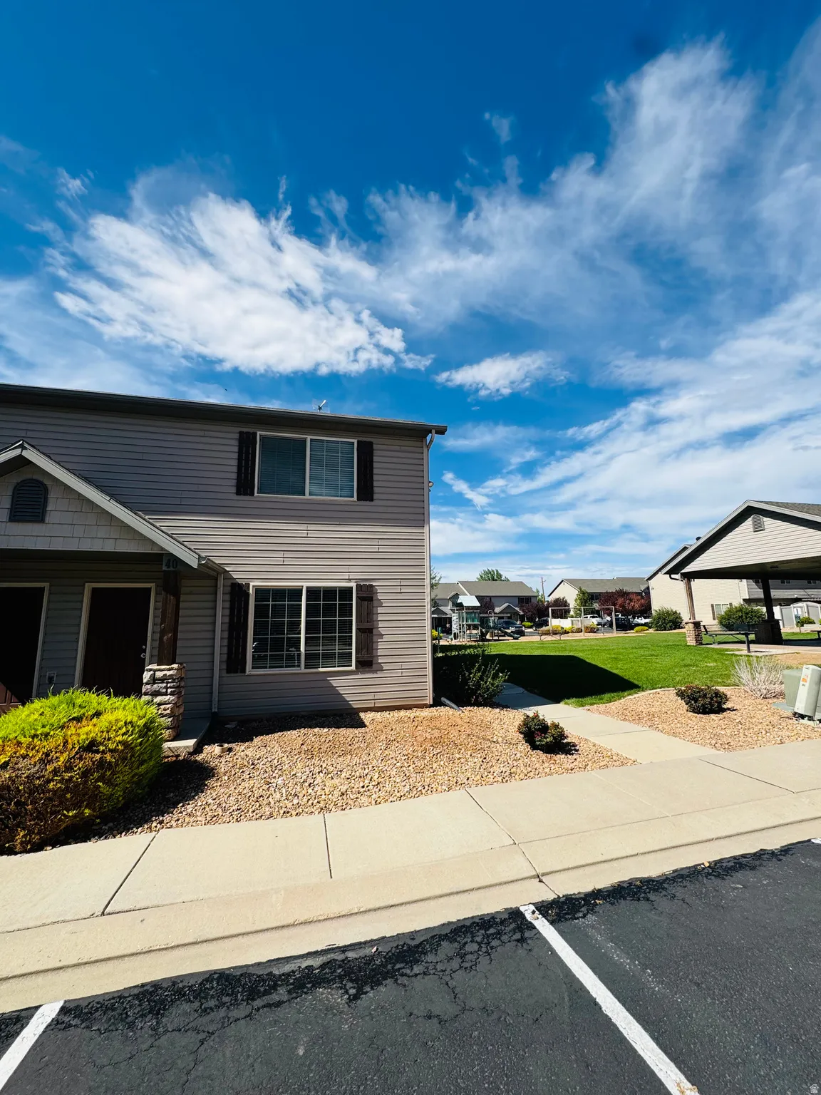 Two-story property with horizontal siding and decorative window shutters