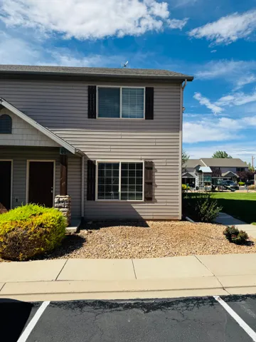 Two-story exterior with horizontal siding and decorative window shutters