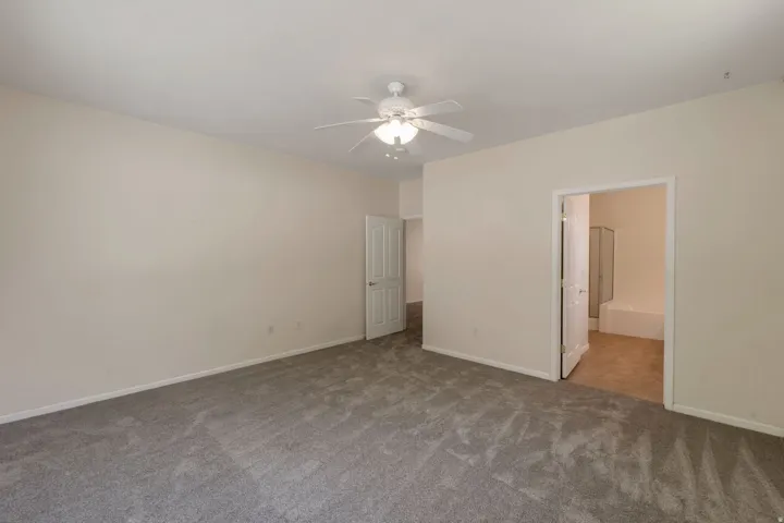 Spacious room featuring neutral carpeting and light-toned walls