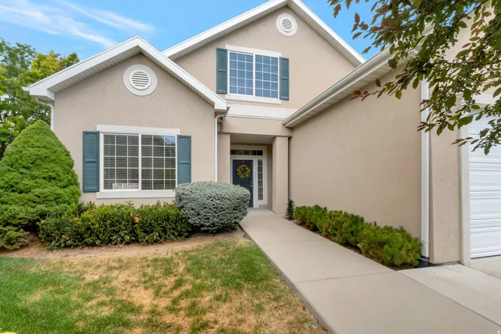 Stucco exterior with gabled roof lines and white trim details