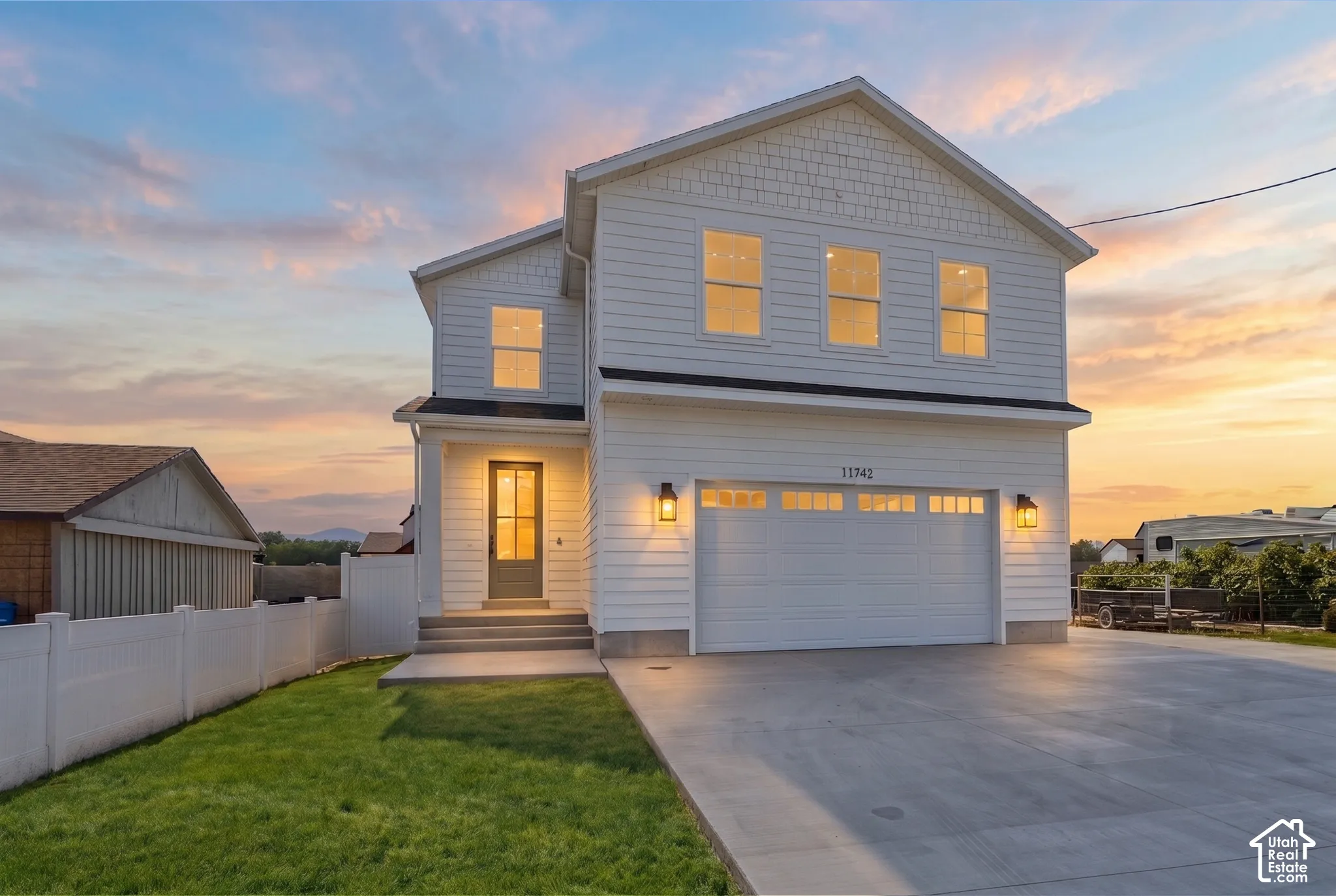 Modern two-story residence featuring white siding and coordinating trim *grass ai generated