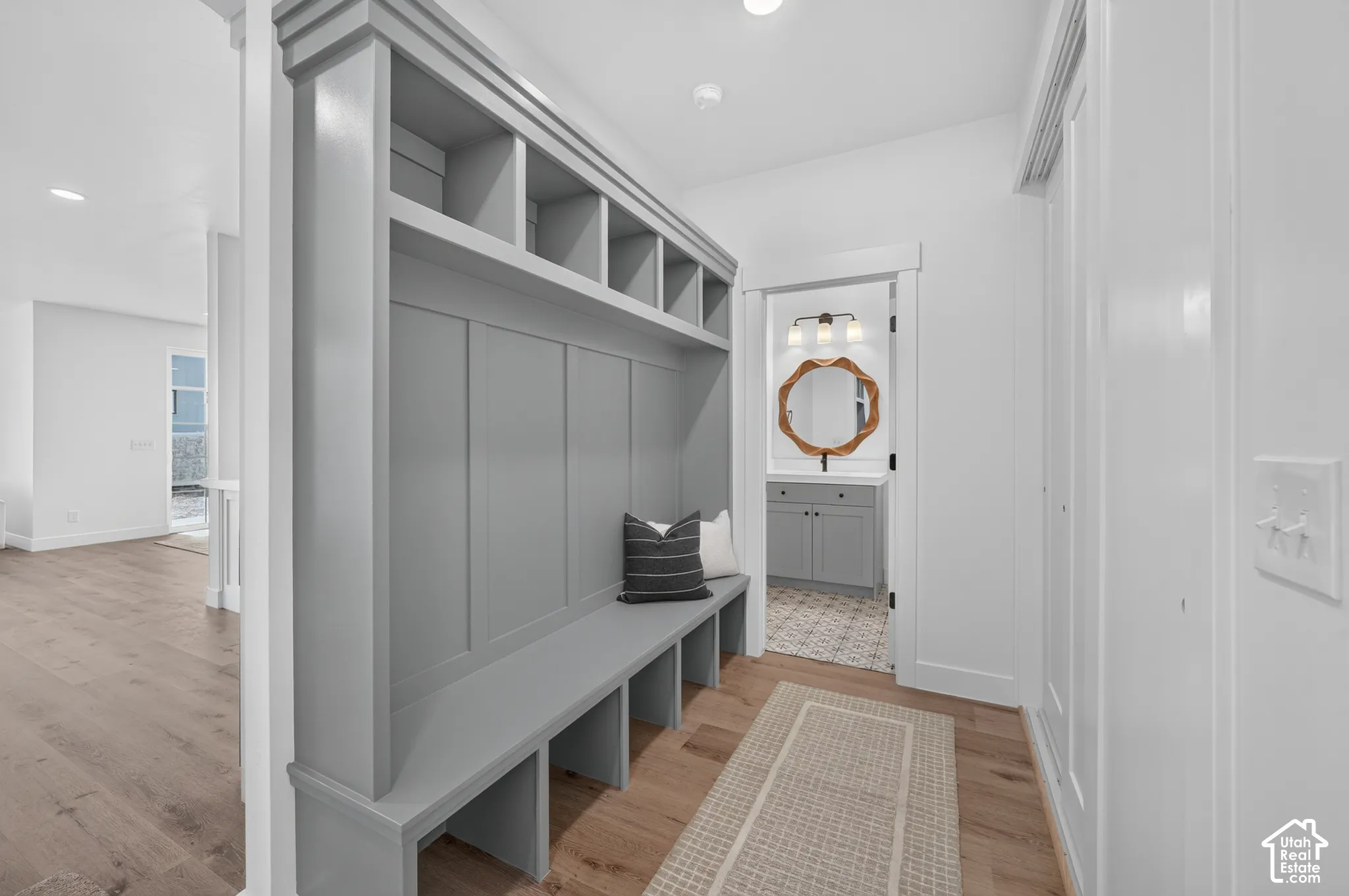 Built-in gray cabinetry with open shelving and bench seating