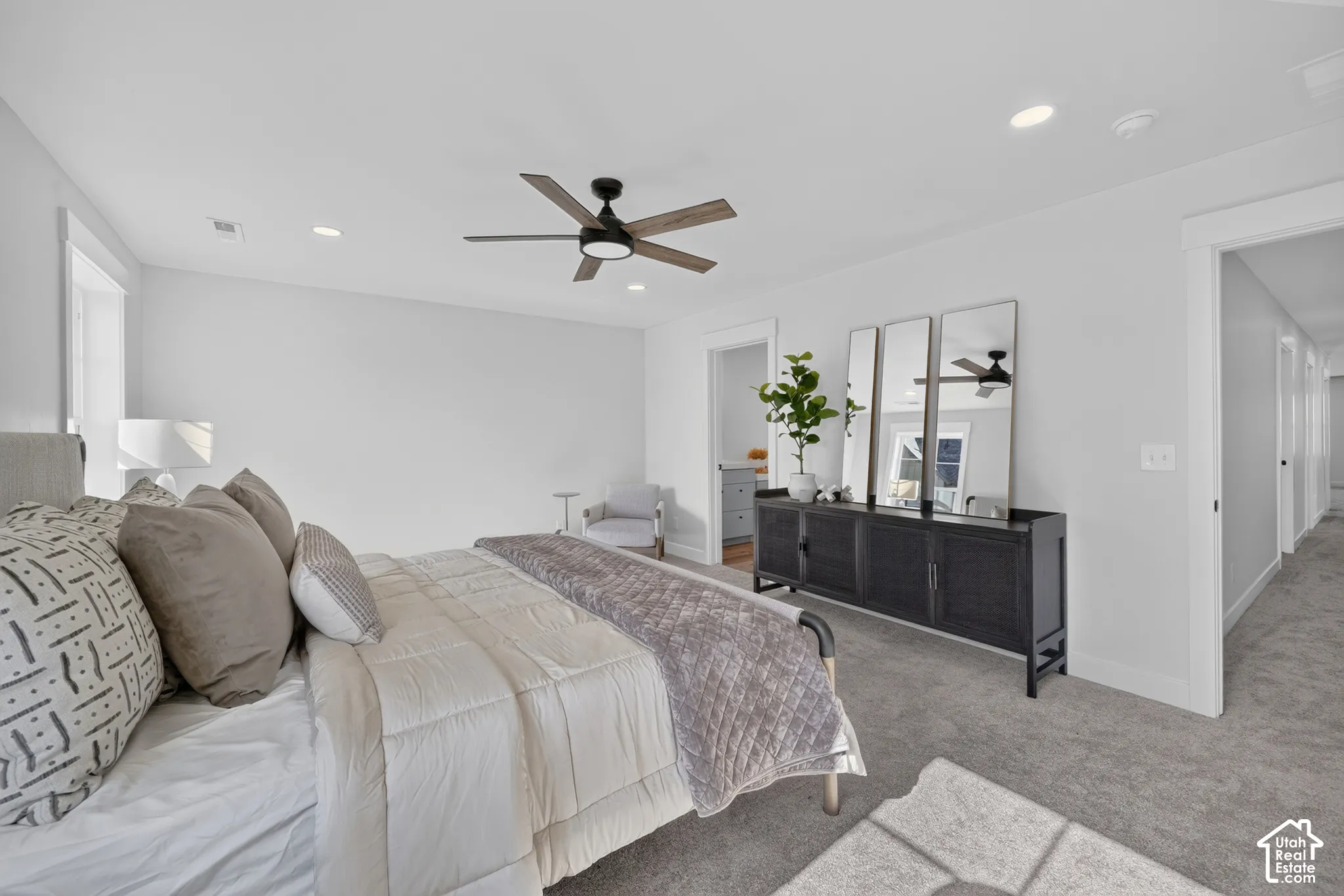 Carpeted bedroom featuring a ceiling fan with integrated lighting, recessed lighting, and white trim