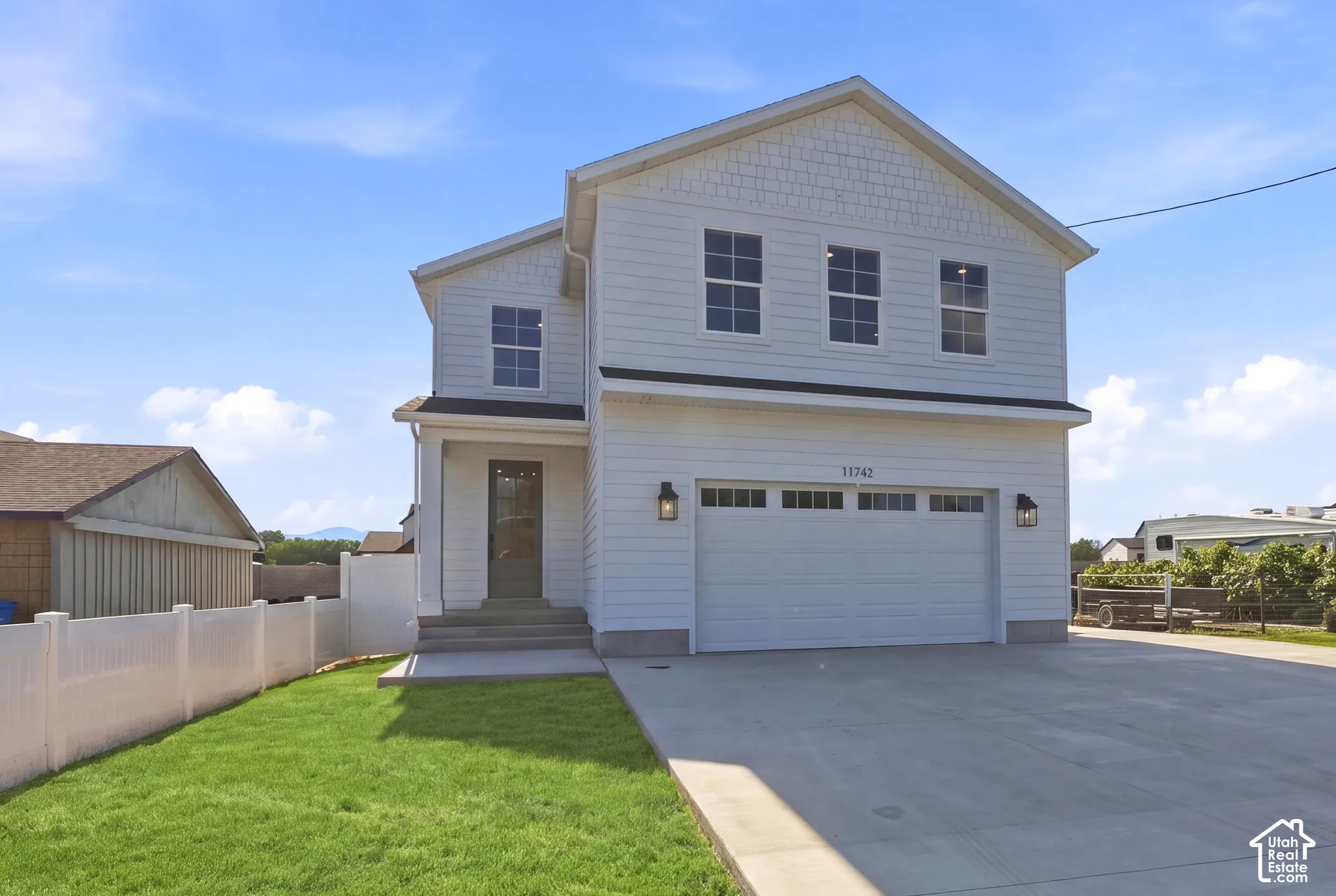 Two-story residence featuring white siding and shake accents *grass ai generated