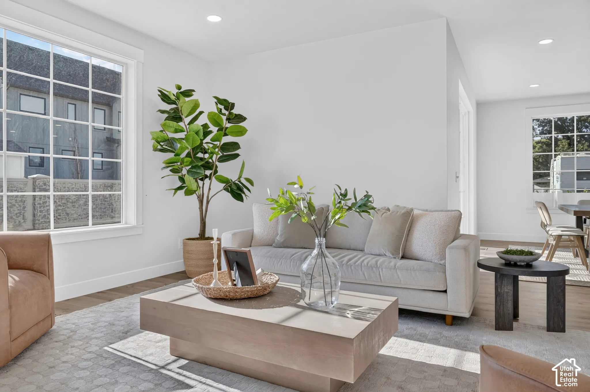 Spacious room featuring wood-finish flooring and recessed lighting