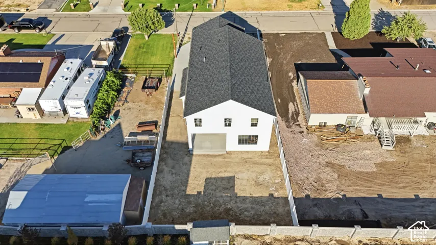 Newly constructed home with a modern white exterior and a dark shingled roof