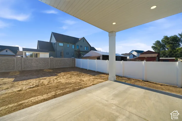 Covered patio with recessed lighting, concrete flooring, and a structural column
