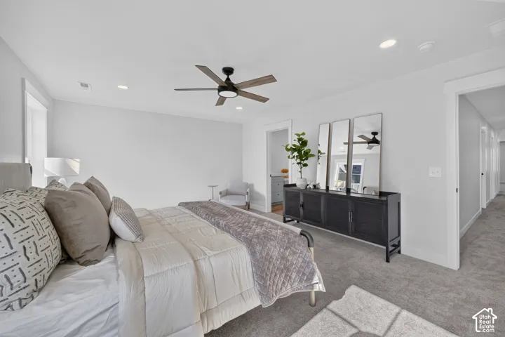 Carpeted bedroom featuring a ceiling fan with integrated lighting, recessed lighting, and white trim