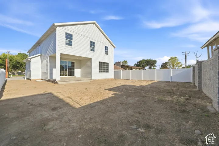 Two-story residential structure featuring white siding and multiple windows