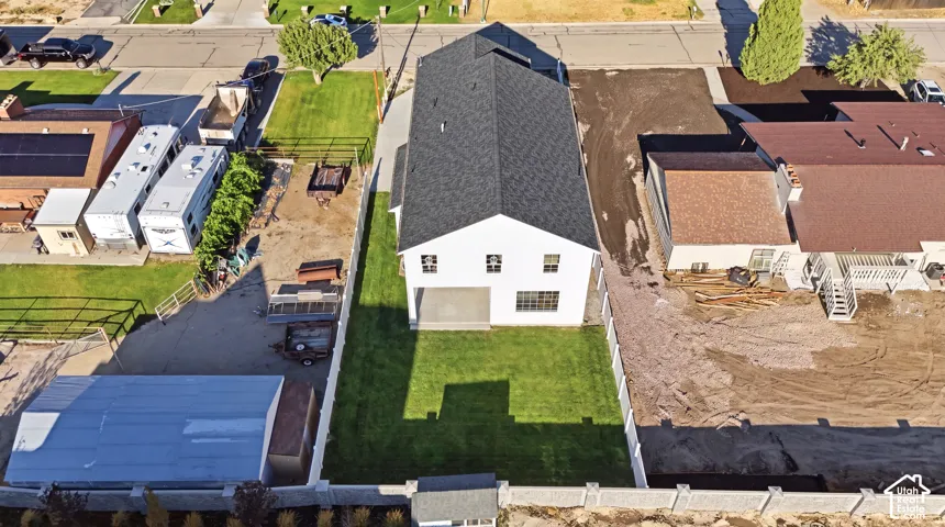 White two-story residence with a dark shingle roof and multiple windows *grass ai generated