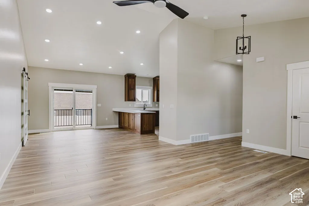 Open-concept living space featuring wood-finish flooring and recessed lighting