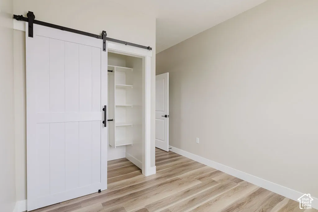 Interior room featuring wood-finish flooring and light neutral walls