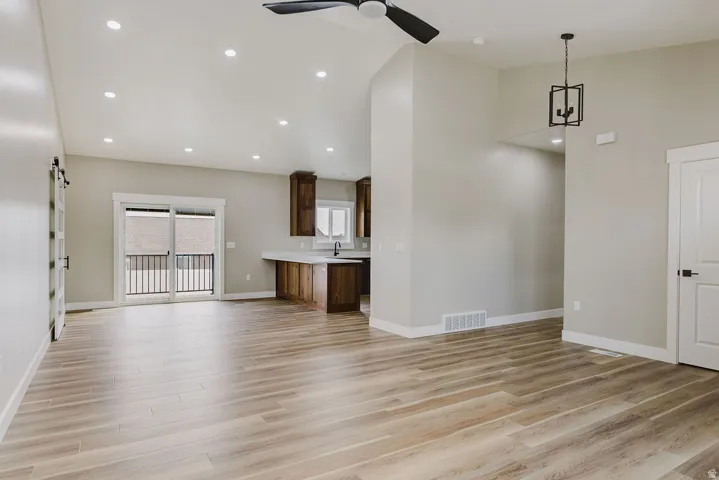 Open-concept living space featuring wood-finish flooring and recessed lighting
