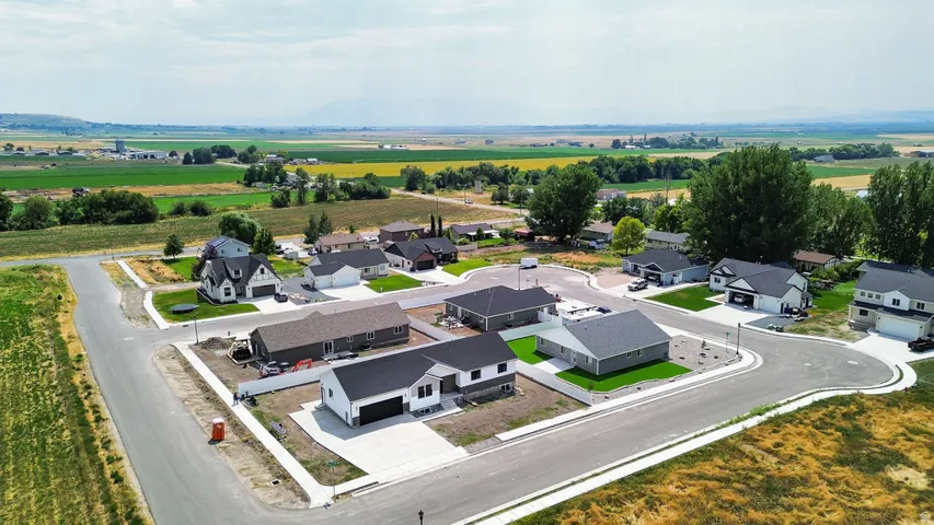Contemporary residential development featuring cul-de-sac streets, new construction homes, and manicured lawns