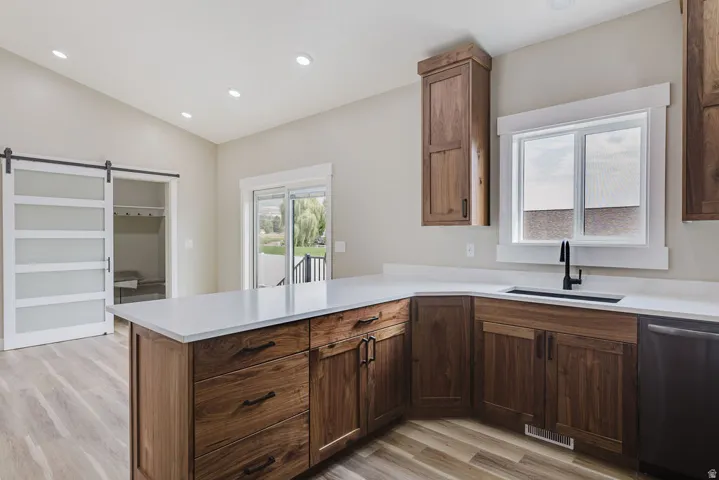Kitchen featuring wood-finish flooring, recessed lighting, and a white countertop