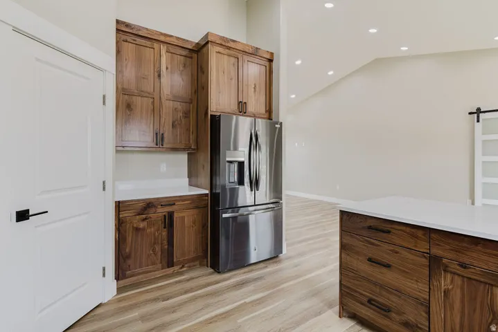 Kitchen featuring wood-finish cabinetry and a stainless steel refrigerator