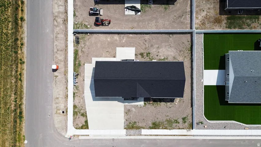 New construction residence featuring a dark shingle roof and a concrete driveway