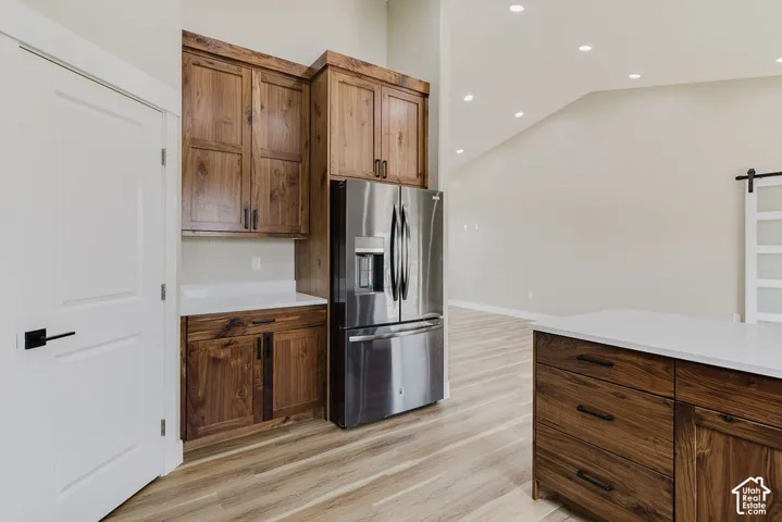 Kitchen featuring wood-finish cabinetry and a stainless steel refrigerator