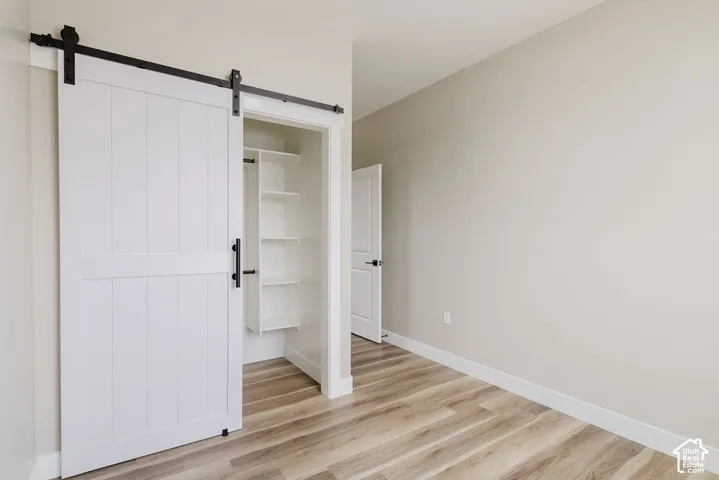 Interior room featuring wood-finish flooring and light neutral walls