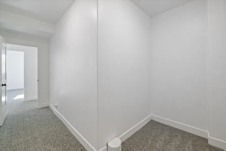 White-painted interior with textured gray carpeting