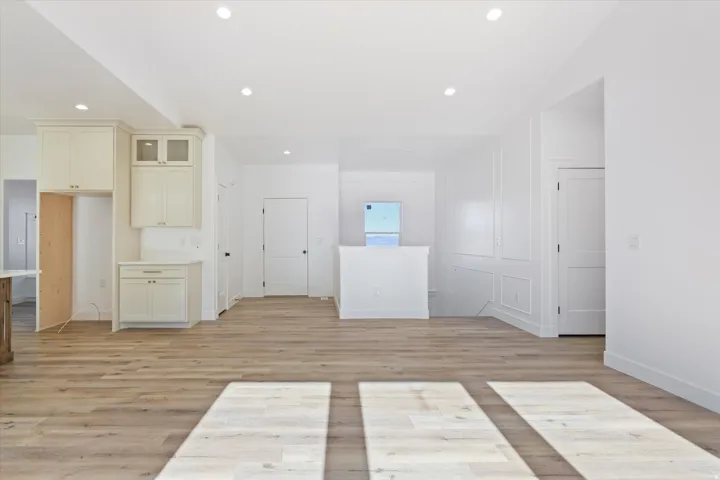 Open-concept interior featuring light wood-finish flooring throughout