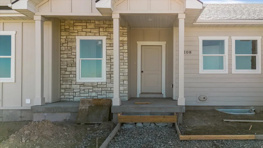 Exterior featuring stone facade accents and horizontal siding