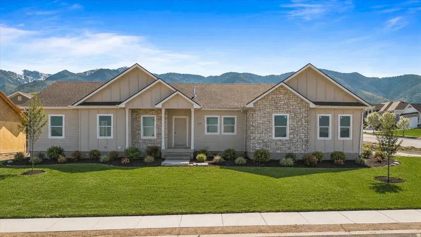 AI Generated Landscaping. It is not included in the price. Ranch-style exterior featuring a light-colored siding, stone accents, a gabled roofline, a covered entry, and a manicured front lawn