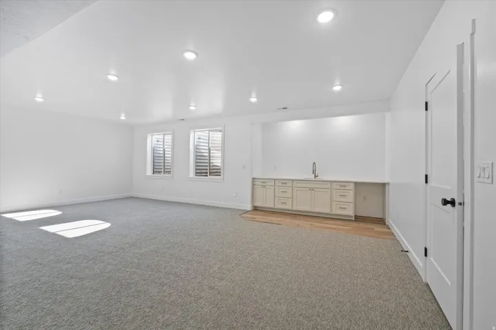 Spacious room featuring recessed lighting and two egress windows
