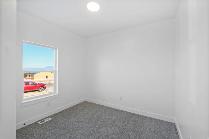 Room featuring a single window, recessed lighting, white walls, and gray carpet