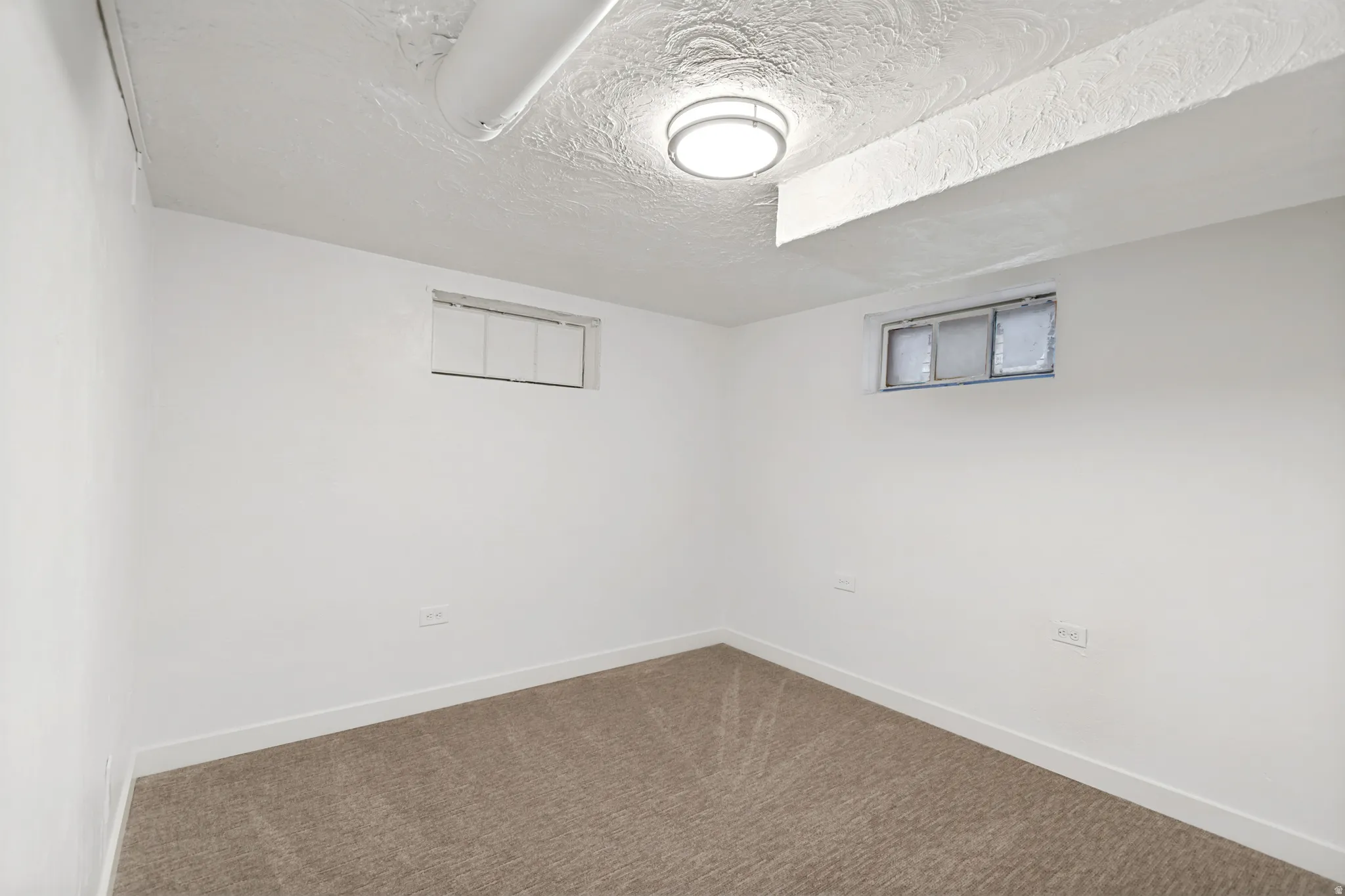Neutral-toned carpeting complements the white walls and trim
