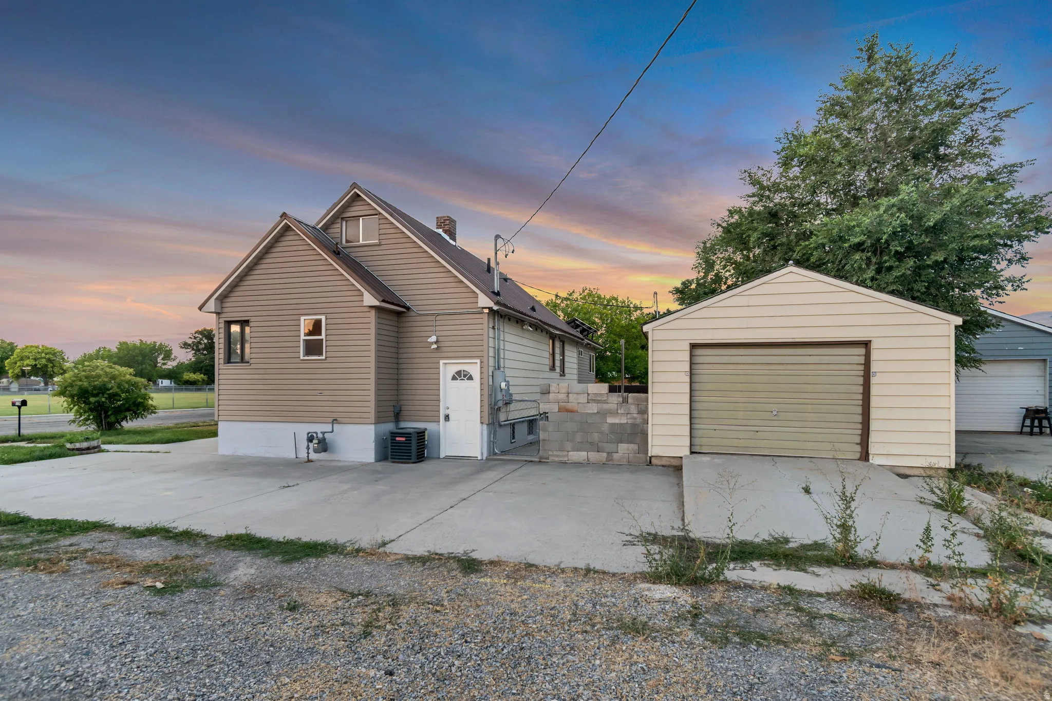 Detached single-car garage featuring a roll-up door
