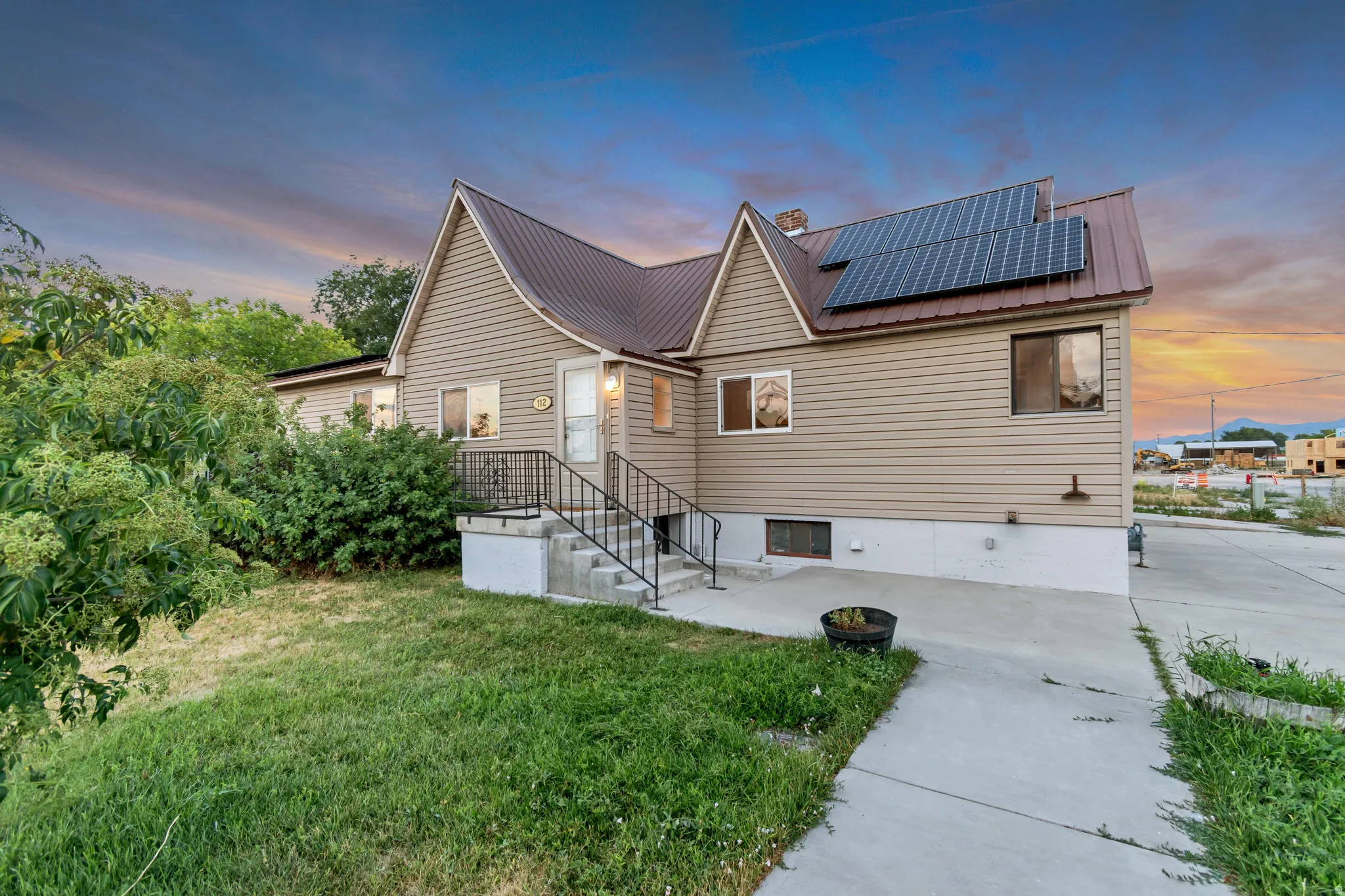 Siding exterior with a metal roof and integrated solar panels