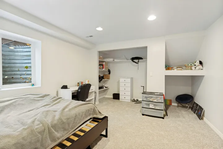 Bedroom featuring light-toned carpeting and recessed lighting